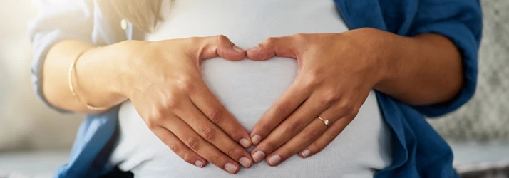 Chiropractic Slinger WI Woman Heart Over Belly Healthy Pregnancy